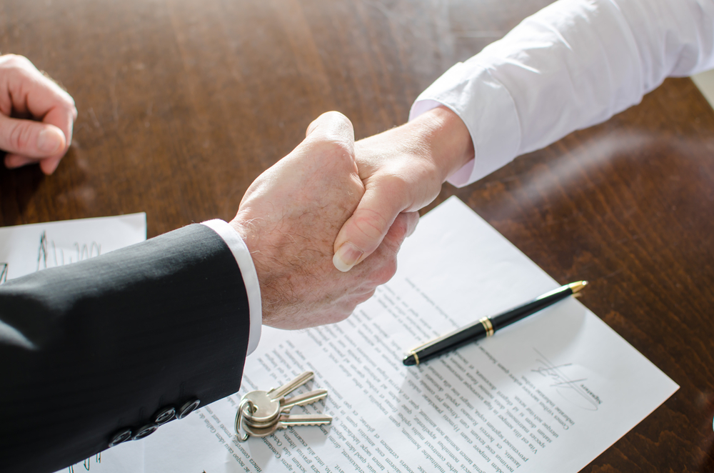 Agent Shaking Hands With His Client After Contract Signing