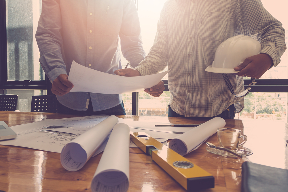 Two architects reviewing plans in an office